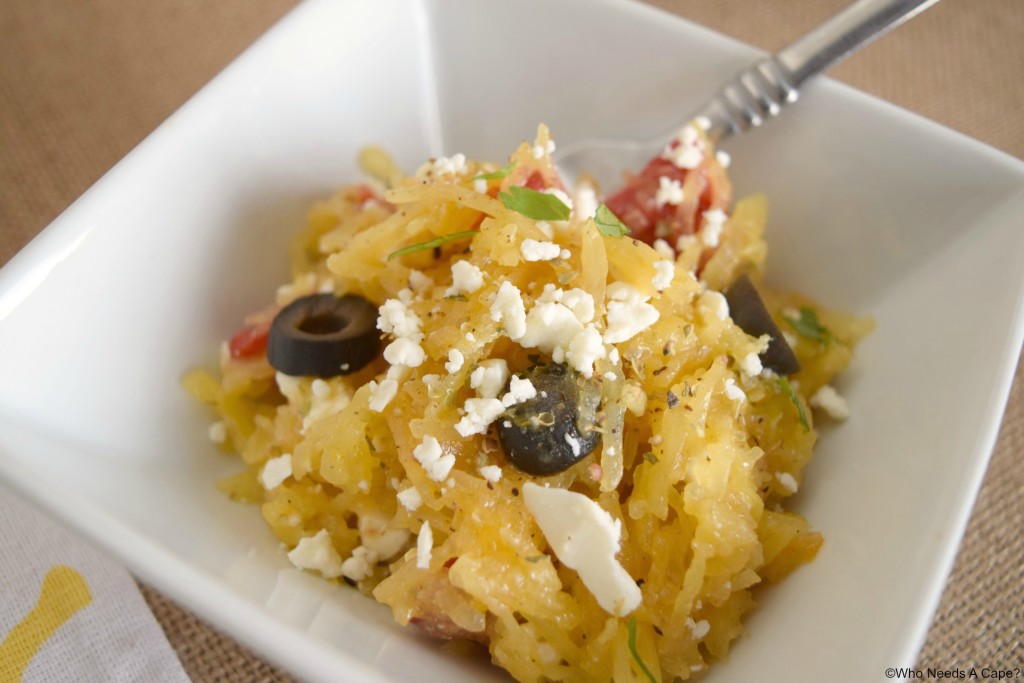 Mediterranean Spaghetti Squash Salad in a white bowl with a fork. 