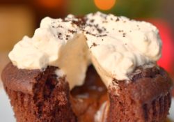 Warm Chocolate Melting Cupcakes are a decadently easy dessert perfect for the holidays! Topped with coffee infused whipped cream, you'll love this dessert!
