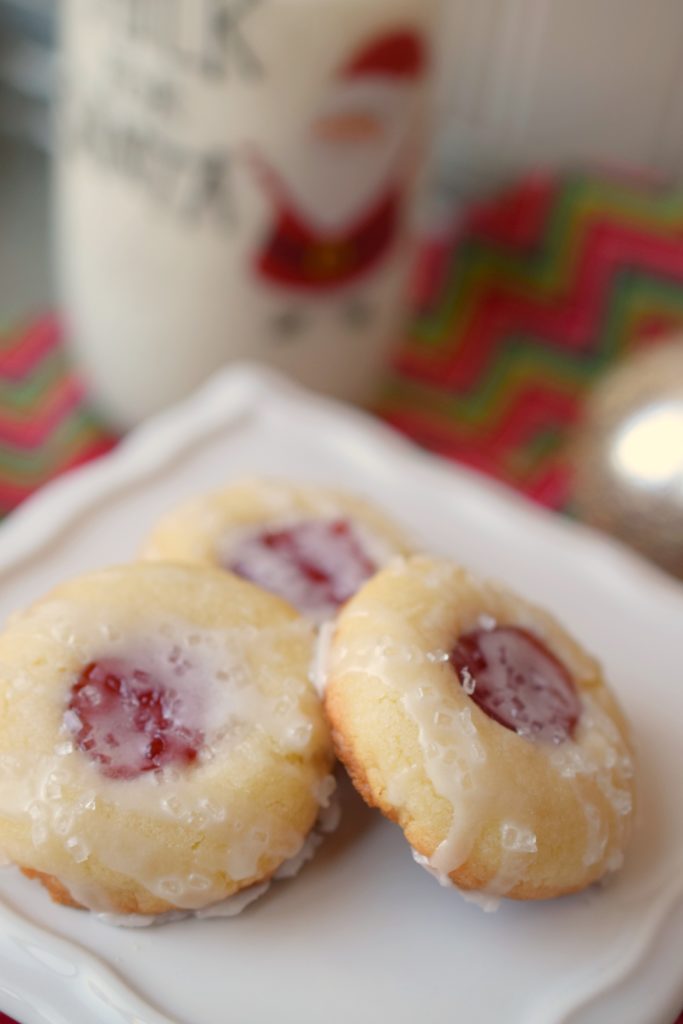 Almond Raspberry Thumbprint Cookies are the perfect addition to holiday cookie trays. Easy to make, full of flavor and perfect with a glass of milk.