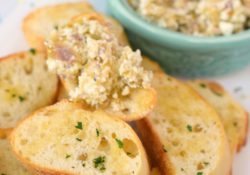 Spicy Green Olive & Feta Tapenade is a great spread to enjoy when entertaining. Easy to make, your guests will love this dip with crusty baguettes.