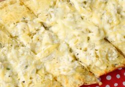 Cheesy Artichoke Loaf is simply an amazing addition to any meal or cookout! Loaded with delicious flavors, you'll love this simple recipe!